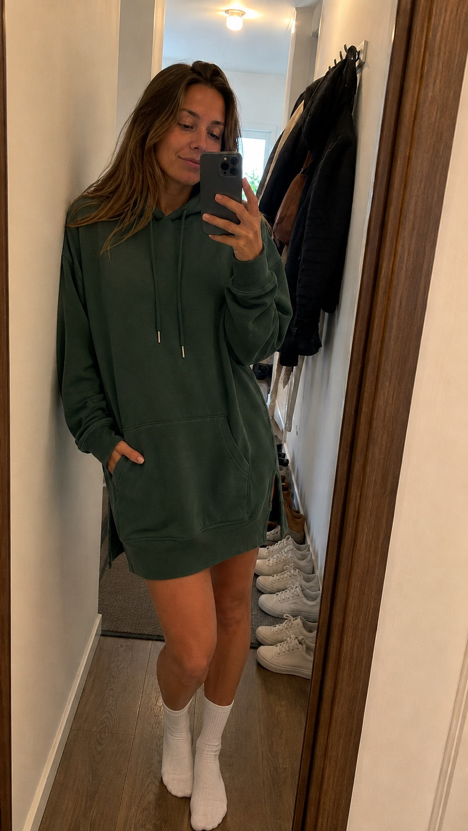 Woman in a Warmy hoodie dress answering the door at home